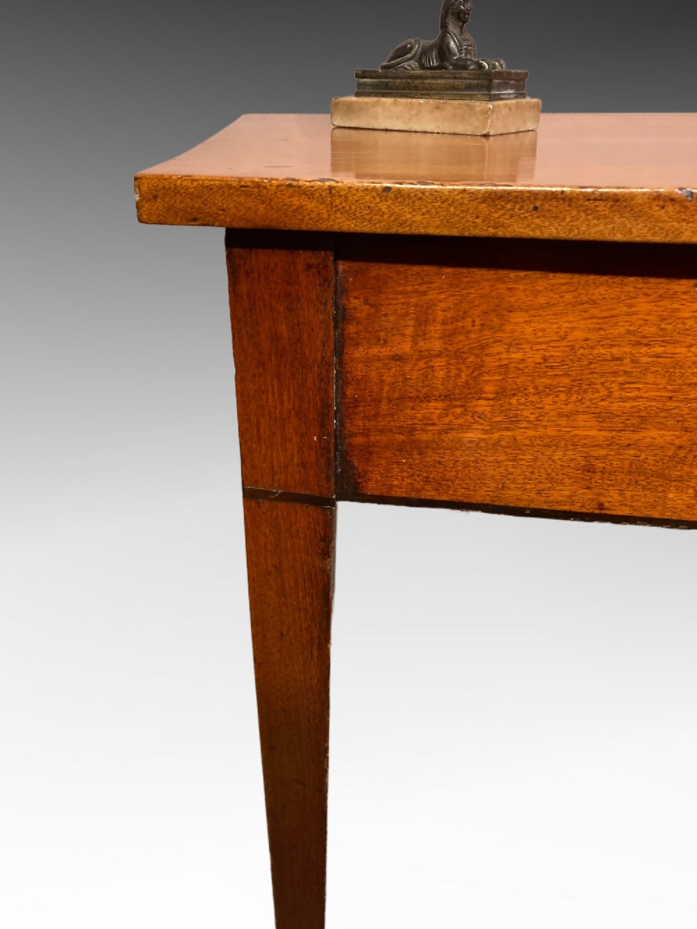 A Georgian mahogany side table featuring a gently curved bow front and four slender square-tapered legs terminating in spade feet. View IV