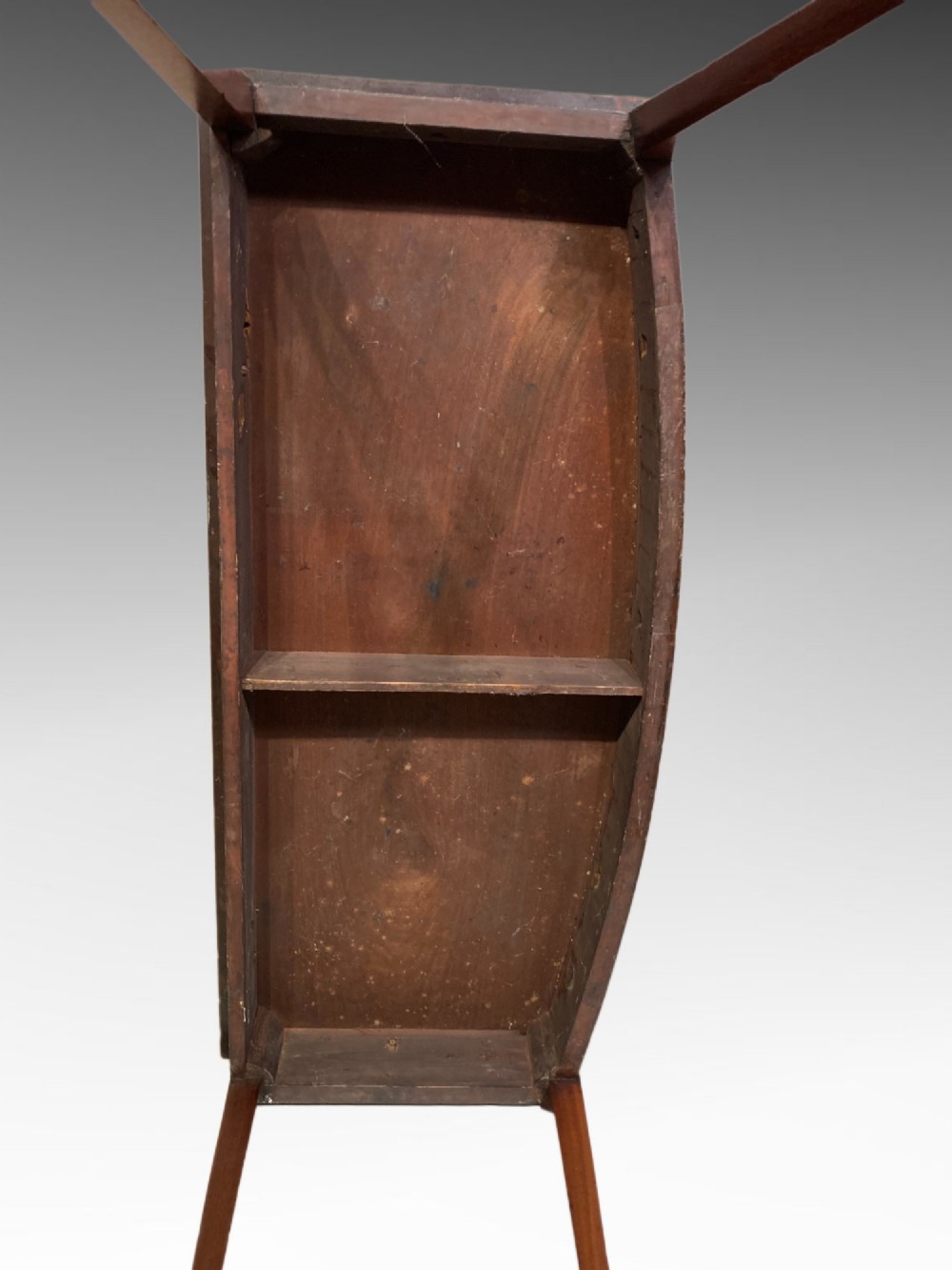 A Georgian mahogany side table featuring a gently curved bow front and four slender square-tapered legs terminating in spade feet. View V