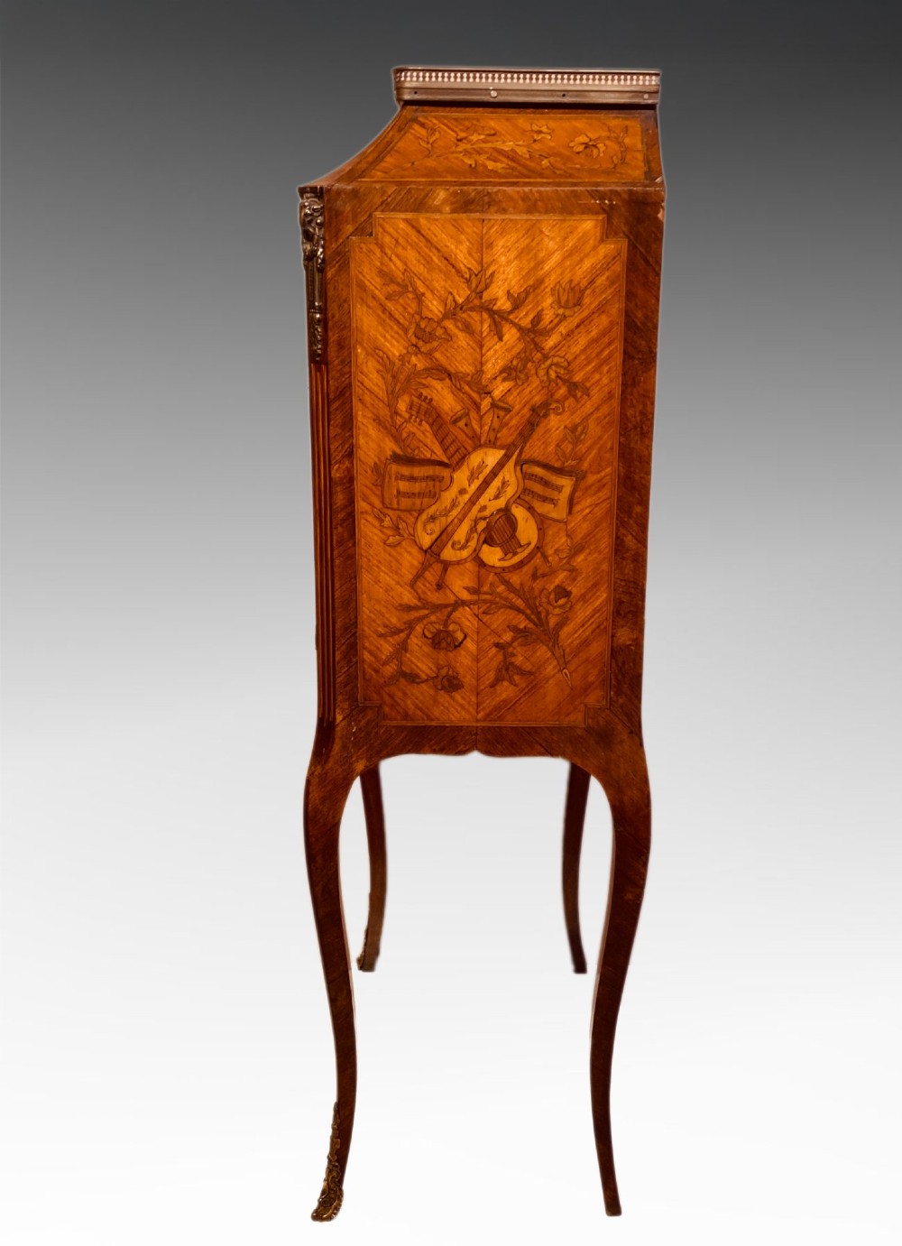 A French Louis XV style kingwood escritoire featuring floral marquetry inlay, slender cabriole legs, a brass top gallery, and gilt-bronze mounts. View II