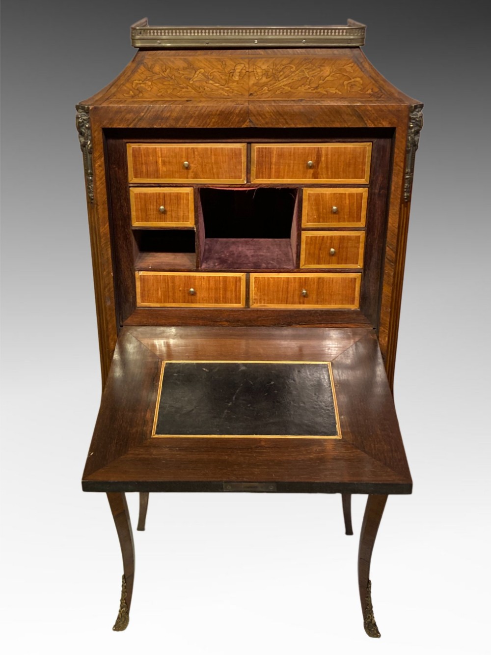 A French Louis XV style kingwood escritoire featuring floral marquetry inlay, slender cabriole legs, a brass top gallery, and gilt-bronze mounts. View III