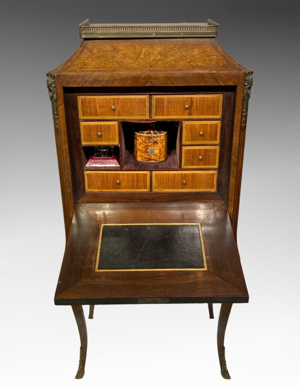 A French Louis XV style kingwood escritoire featuring floral marquetry inlay, slender cabriole legs, a brass top gallery, and gilt-bronze mounts. View VIII