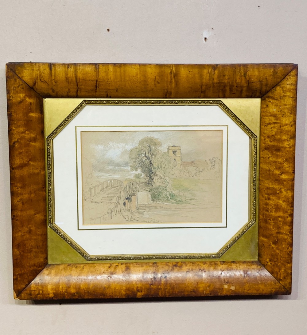 An antique watercolour painting depicting a church, bridge, and trees, set within an octagonal gilded mount and a wide figured wood frame.