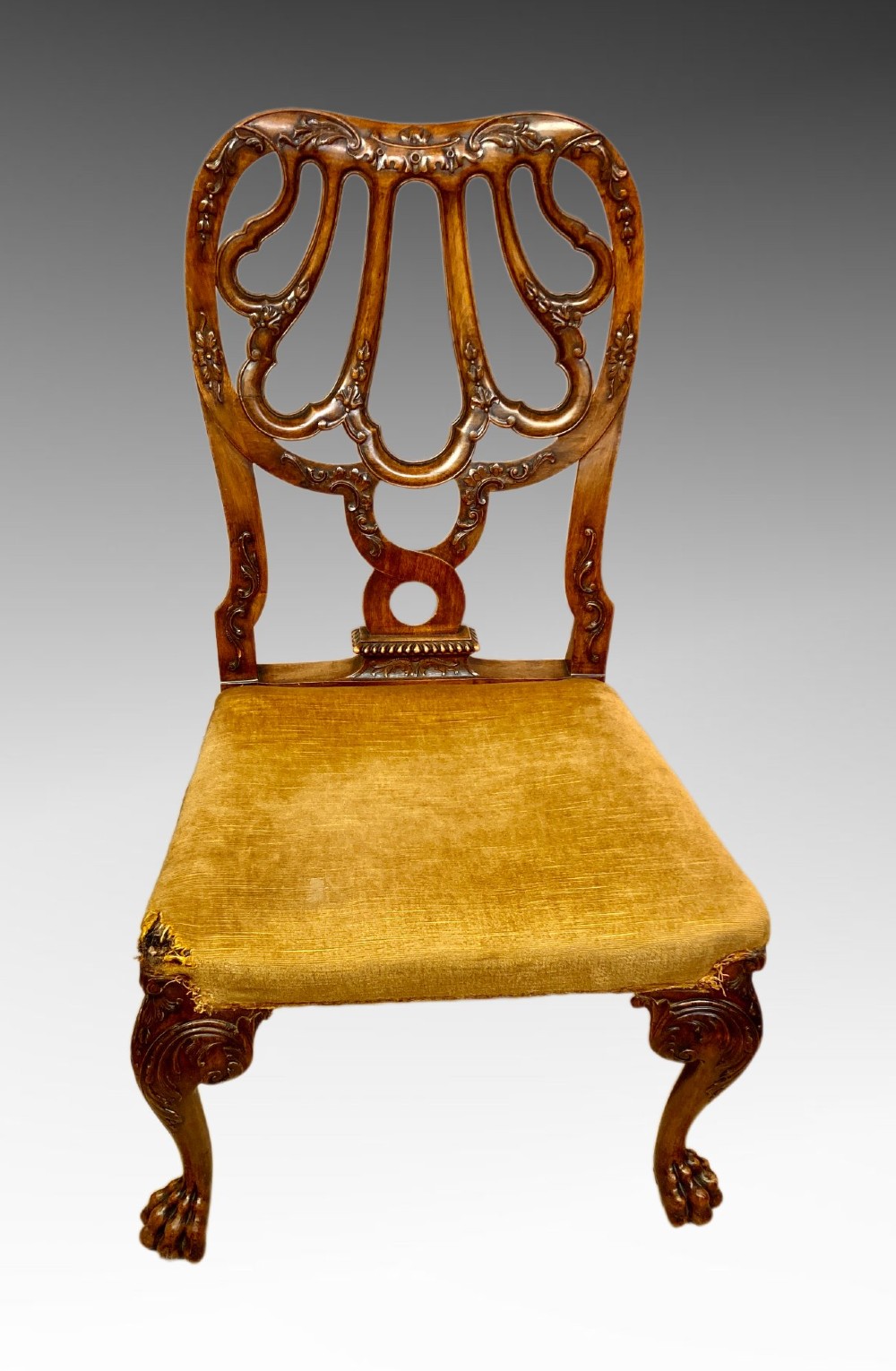 A pair of carved George II style walnut side chairs featuring open shell-form backs, upholstered gold velvet seats, and cabriole legs ending in ball and claw feet. View IV