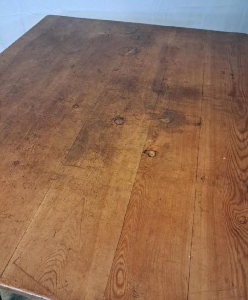 fig 1. A small rustic pine table featuring turned legs, a rectangular top, and integrated drawers fitted with brass cup handles.