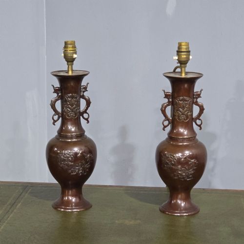 fig 1. A pair of dark patinated Japanese bronze vase table lamps with dragon handles and flared cream fabric shades.