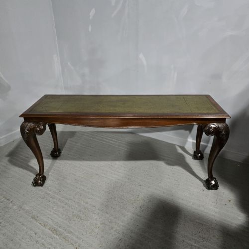fig 1. A mahogany console table featuring a green gold-tooled leather inset top and carved cabriole legs ending in ball-and-claw feet.