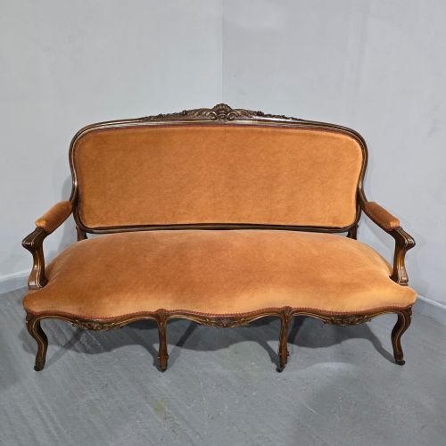 fig 1. A French Louis XV style carved walnut settee with warm amber velvet upholstery, serpentine seat rail, and cabriole legs.