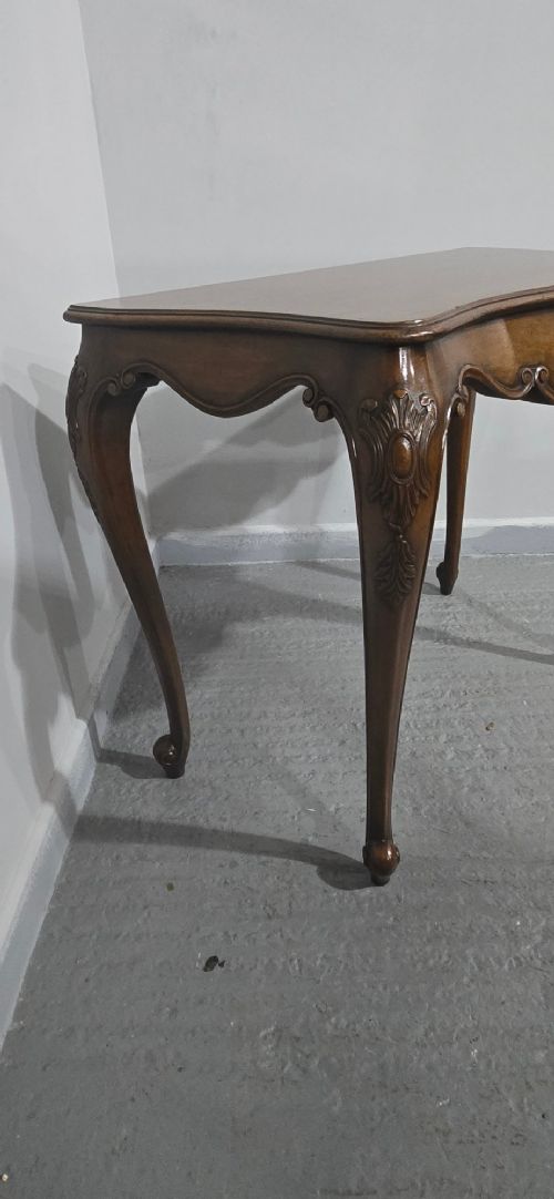 A dark mahogany console table featuring a shaped serpentine top, a central shell carving on the apron, and four cabriole legs. View XIII