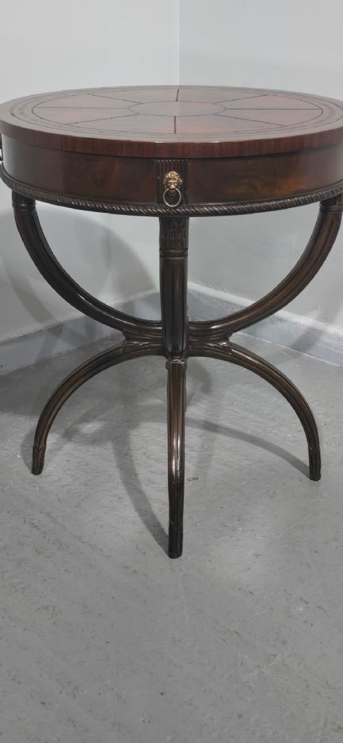 A circular mahogany occasional centre table with a segmented veneered top, brass lion mask handle, and curved reeded legs. View III