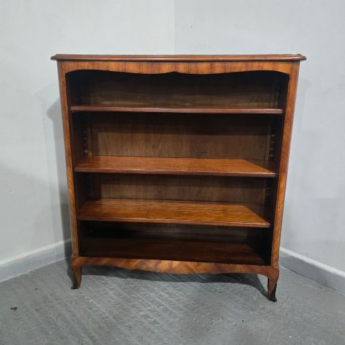 fig 1. An open-fronted French walnut bookcase featuring adjustable internal shelves, a shaped apron, and short cabriole legs.