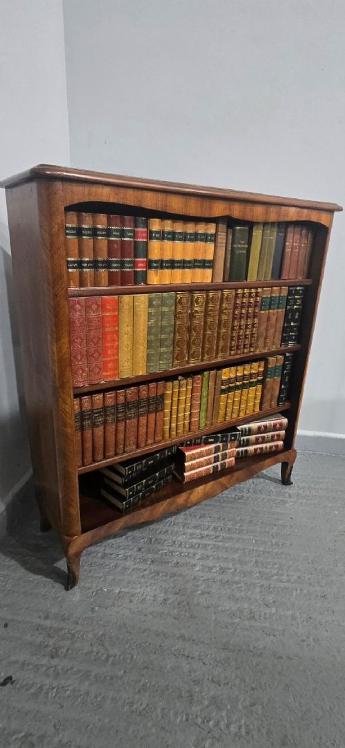 An open-fronted French walnut bookcase featuring adjustable internal shelves, a shaped apron, and short cabriole legs. View XIII