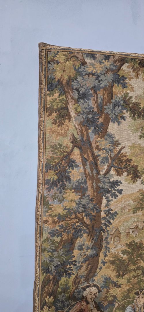 A pair of vertical woven French tapestries depicting men and hounds hunting within a dense green forest and natural landscape. View VI