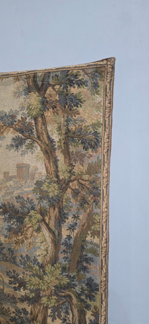 A pair of vertical woven French tapestries depicting men and hounds hunting within a dense green forest and natural landscape. View VII