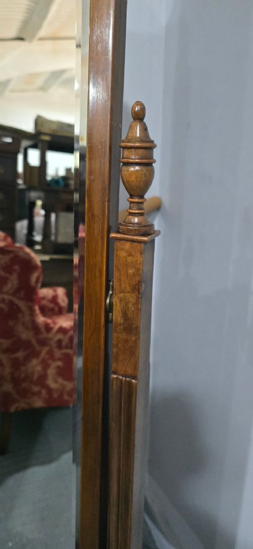 A standing Queen Anne style burr walnut cheval mirror featuring a shaped crest, tilting glass plate, finial-topped uprights, and cabriole legs. View VIII