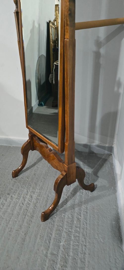 A standing Queen Anne style burr walnut cheval mirror featuring a shaped crest, tilting glass plate, finial-topped uprights, and cabriole legs. View XI