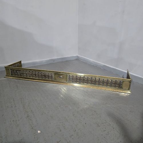 fig 1. A wide Georgian brass and pierced cut steel fireplace fender with decorative geometric patterns and beaded borders.