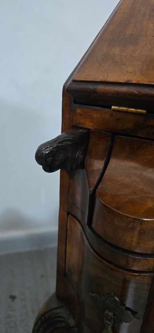 A Queen Anne style burr walnut writing bureau featuring a sloped front lid, shaped drawers with brass drop handles, and tall cabriole legs. View IV