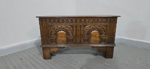 fig 1. A miniature dark oak coffer featuring carved double arches on the front panel and a hinged rectangular lid.