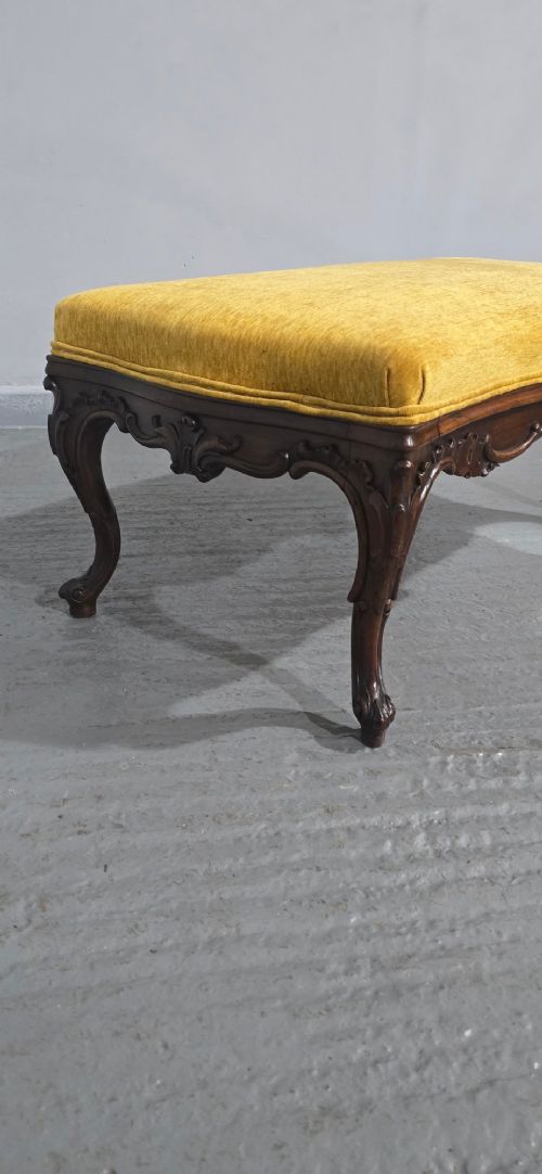 A rectangular Regency period stool featuring a mustard yellow fabric top resting on a dark carved rosewood frame with cabriole legs. View VII