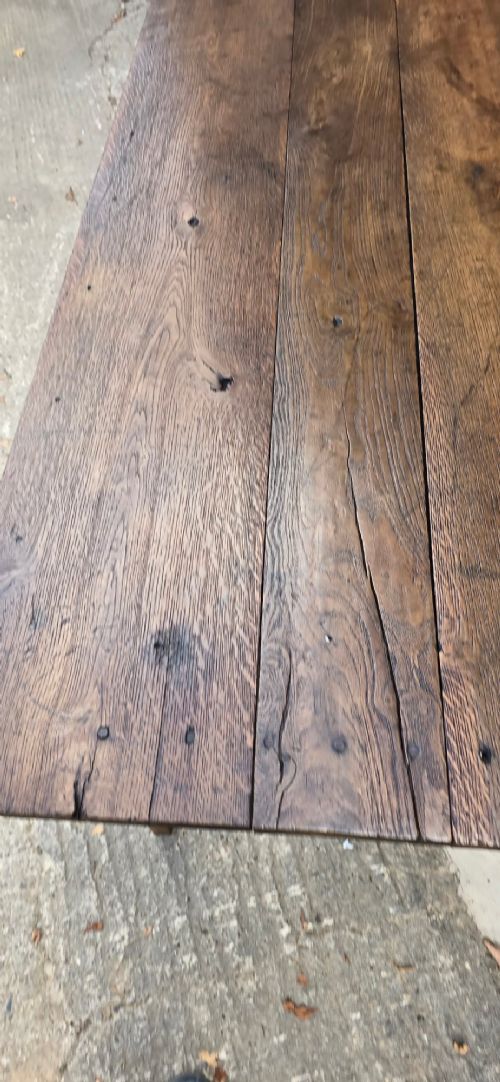 An antique rustic French wooden refectory dining table featuring a three-plank top, single side drawer, and square tapered legs. View VII