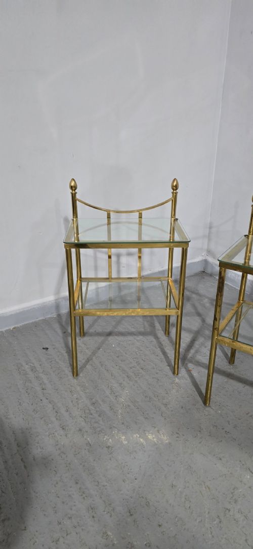 Pair of two-tier brass side tables with clear glass shelves and decorative finials. View VII