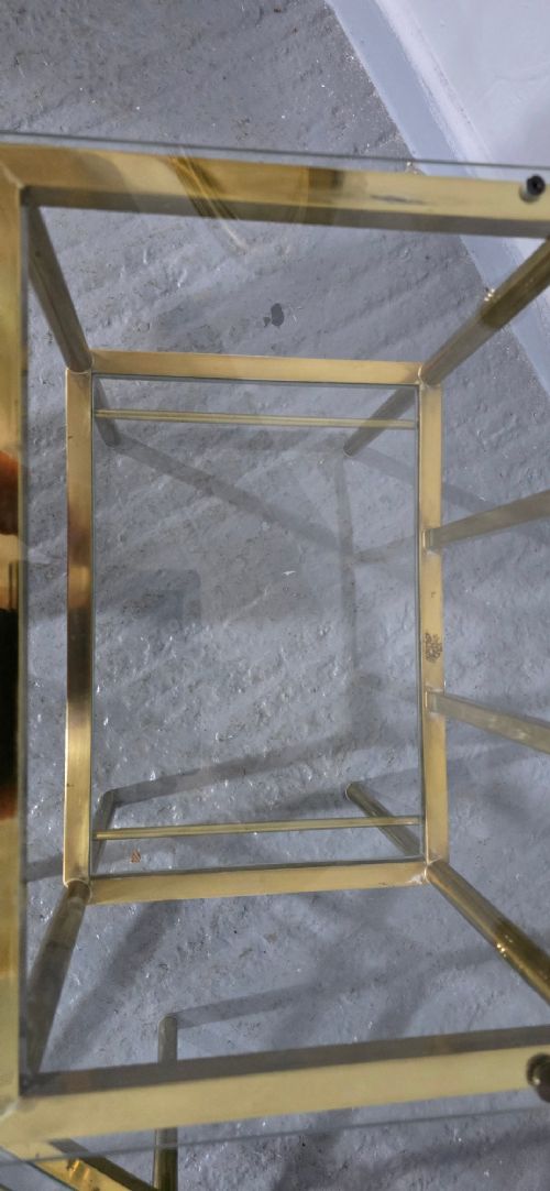 Pair of two-tier brass side tables with clear glass shelves and decorative finials. View VIII