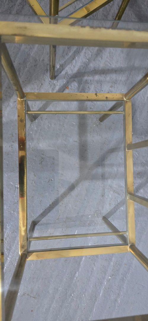 Pair of two-tier brass side tables with clear glass shelves and decorative finials. View X