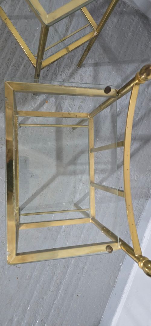 Pair of two-tier brass side tables with clear glass shelves and decorative finials. View XI