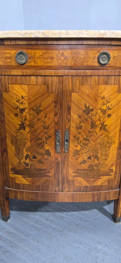 A French Louis XVI style demi-lune cabinet featuring intricate floral marquetry inlay, gilt-bronze mounts, and a contoured marble top. View V