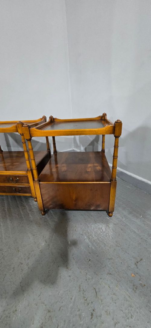 A pair of yew wood lamp tables featuring dark green leather inset tops, a middle shelf, two drawers with brass handles, and turned corner columns. View IX