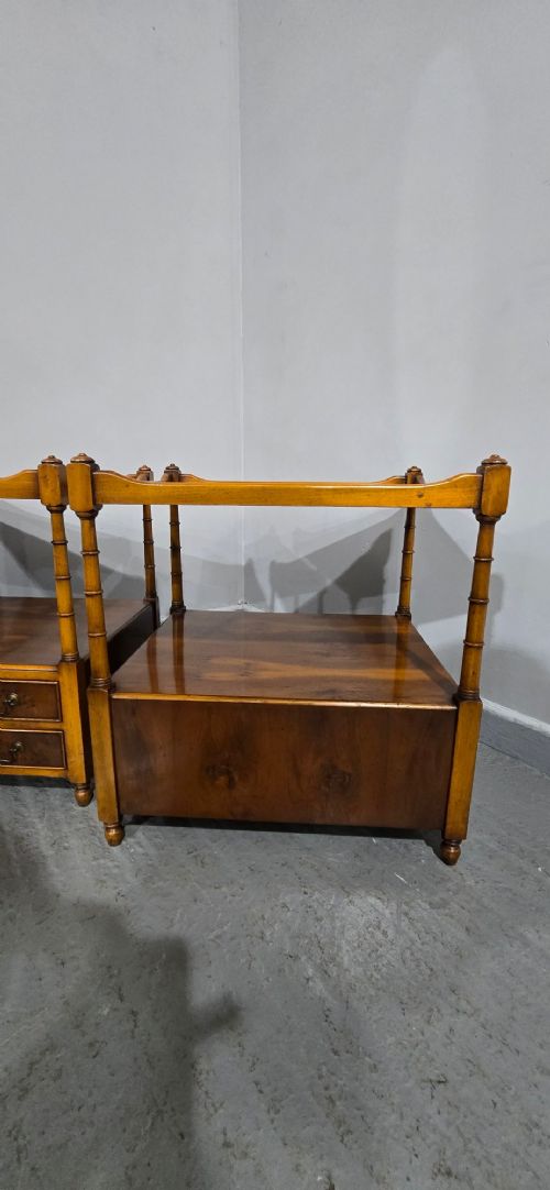 A pair of yew wood lamp tables featuring dark green leather inset tops, a middle shelf, two drawers with brass handles, and turned corner columns. View X