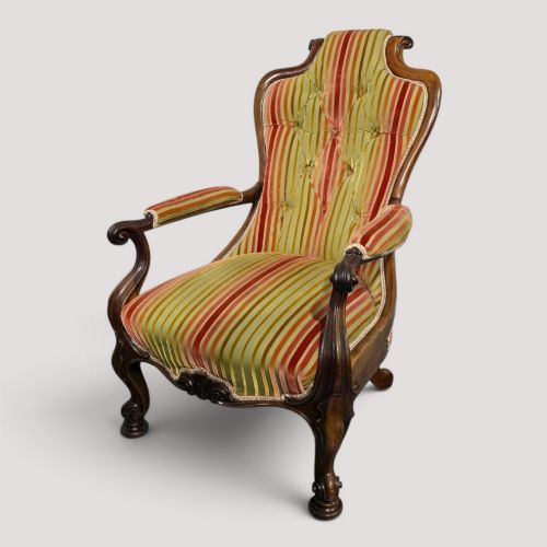 fig 1. A Regency rosewood armchair featuring a button-tufted backrest, scrolled arms, carved legs, and striped green and red upholstery.