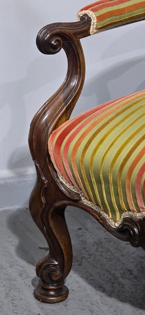 A Regency rosewood armchair featuring a button-tufted backrest, scrolled arms, carved legs, and striped green and red upholstery. View III