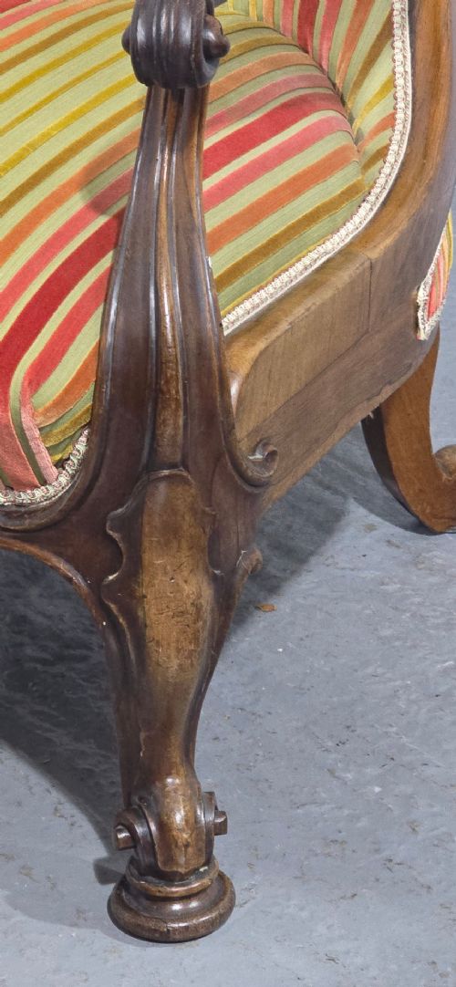 A Regency rosewood armchair featuring a button-tufted backrest, scrolled arms, carved legs, and striped green and red upholstery. View IV