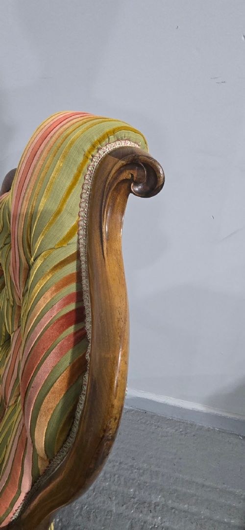A Regency rosewood armchair featuring a button-tufted backrest, scrolled arms, carved legs, and striped green and red upholstery. View VII