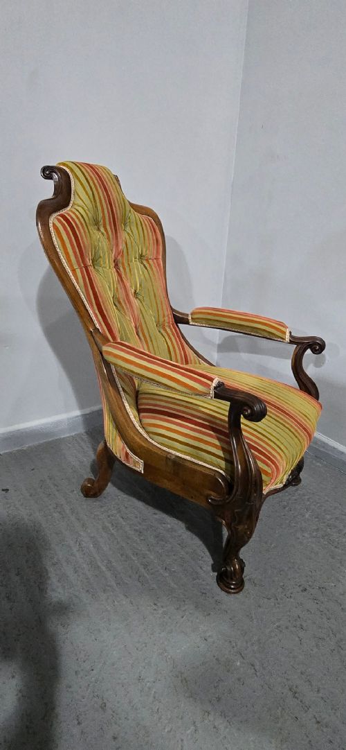 A Regency rosewood armchair featuring a button-tufted backrest, scrolled arms, carved legs, and striped green and red upholstery. View XI