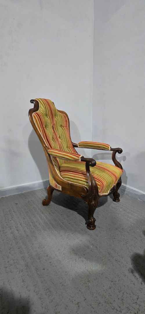 A Regency rosewood armchair featuring a button-tufted backrest, scrolled arms, carved legs, and striped green and red upholstery. View XII