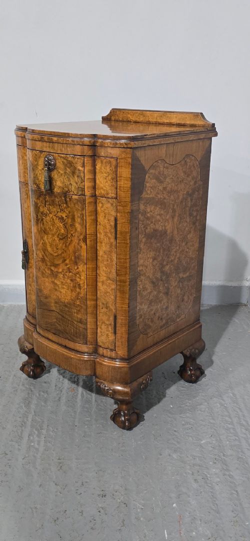 A small burr walnut side cabinet with a single upper drawer over a cupboard door, raised on carved cabriole legs with claw-and-ball feet. View IV