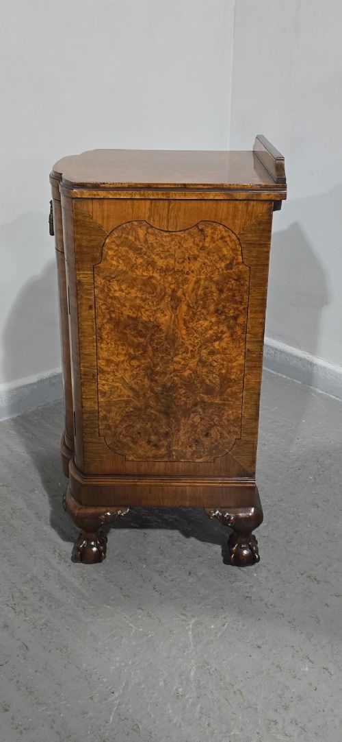 A small burr walnut side cabinet with a single upper drawer over a cupboard door, raised on carved cabriole legs with claw-and-ball feet. View VII