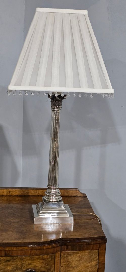 A pair of silver-plated neoclassical column table lamps with square stepped plinths and white pleated shades featuring beaded lower trim. View III