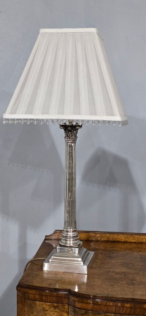 A pair of silver-plated neoclassical column table lamps with square stepped plinths and white pleated shades featuring beaded lower trim. View IV