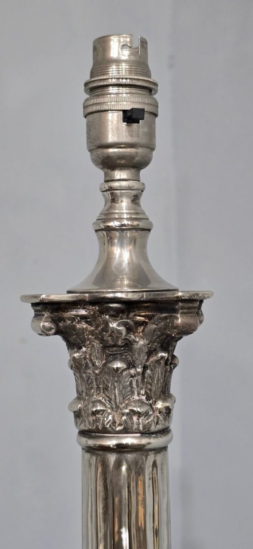 A pair of silver-plated neoclassical column table lamps with square stepped plinths and white pleated shades featuring beaded lower trim. View XII