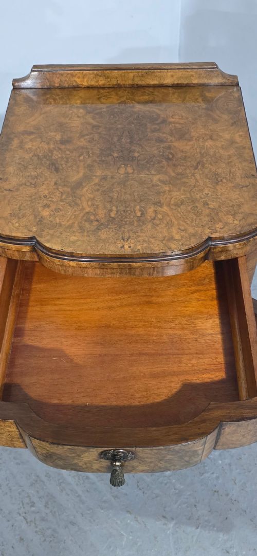 A burr walnut side cabinet with a bowed front, single drawer, cupboard door, and cabriole legs ending in carved claw and ball feet. View XI