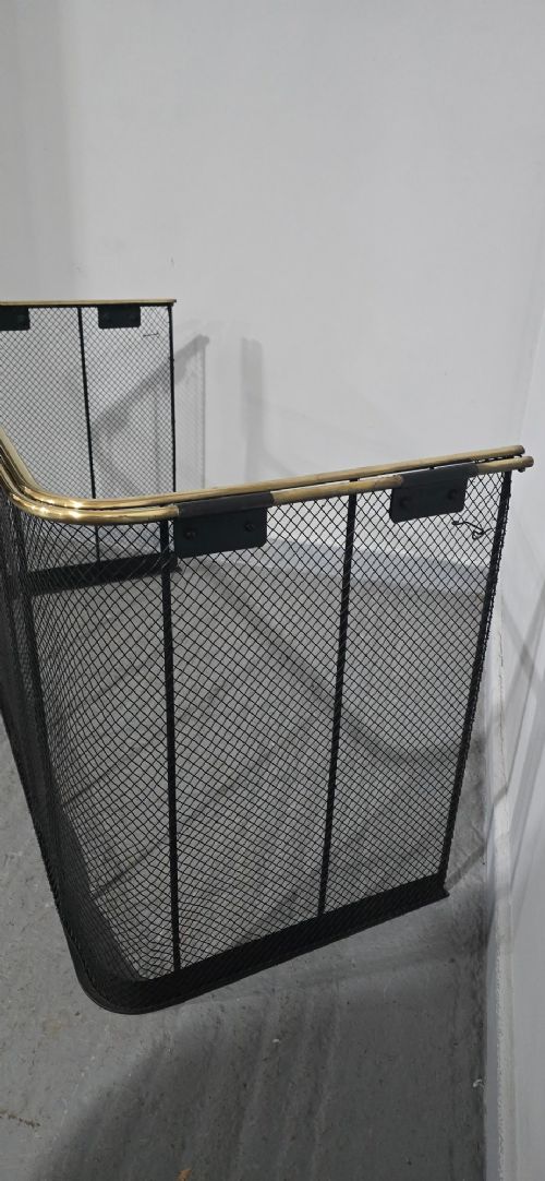 An early Victorian three-sided nursery fire guard featuring black woven wire mesh, vertical reinforcing bars, and a polished brass top rail. View V