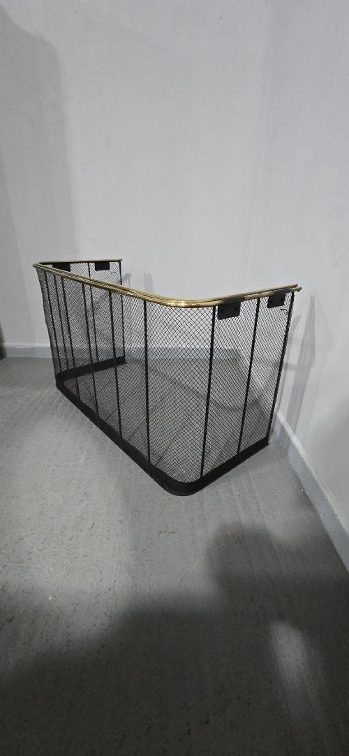 An early Victorian three-sided nursery fire guard featuring black woven wire mesh, vertical reinforcing bars, and a polished brass top rail. View VI