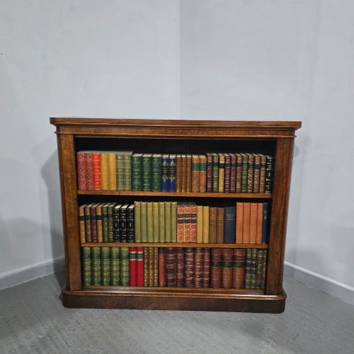 fig 1. A solid mahogany Victorian open bookcase featuring adjustable internal shelves and a solid plinth base filled with books.
