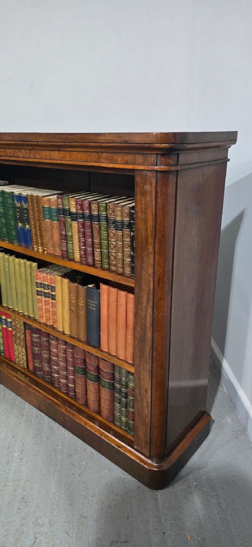 A solid mahogany Victorian open bookcase featuring adjustable internal shelves and a solid plinth base filled with books. View IV