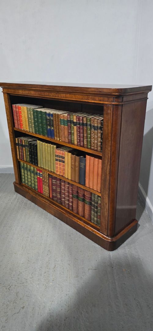 A solid mahogany Victorian open bookcase featuring adjustable internal shelves and a solid plinth base filled with books. View V