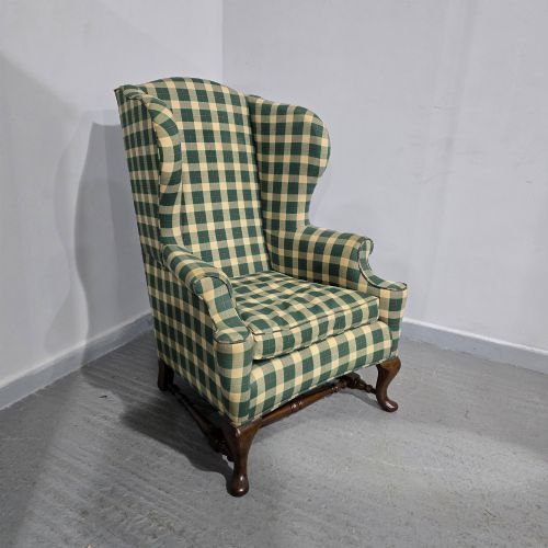 fig 1. High-backed wingback armchair upholstered in green and cream check fabric with carved oak cabriole front legs.