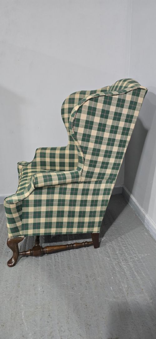 High-backed wingback armchair upholstered in green and cream check fabric with carved oak cabriole front legs. View V